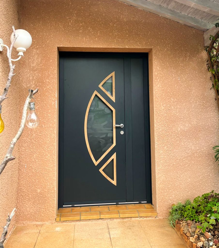 Entrée de maison présentant une porte avec un panneau décoratif coloris gris anthracite